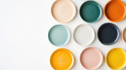 Colorful ceramic plates arranged in top view display, showcasing various shades and textures, creating vibrant and artistic composition