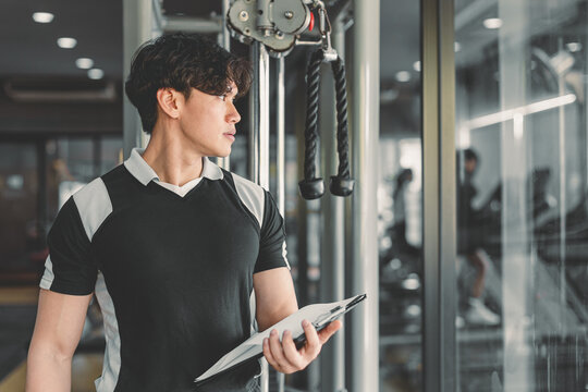 sport healthy asian women sitting in gym fitness using tablet, learning online sports training