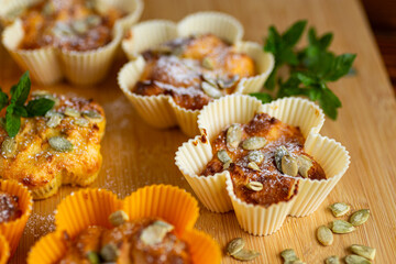 Homemade cottage cheese muffins with pumpkin seeds on board