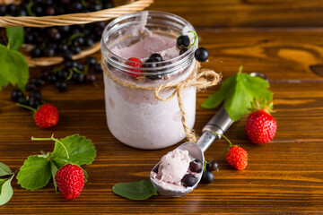 Refreshing berry ice cream on wooden background