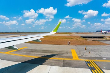 Aerial view. An airplane wing against the backdrop of provincial Thailand.