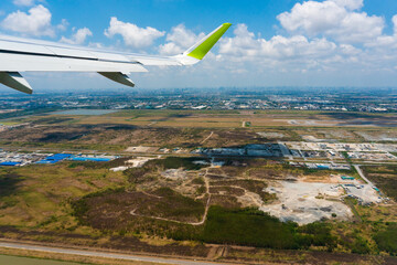 Aerial view. An airplane wing against the backdrop of provincial Thailand.
