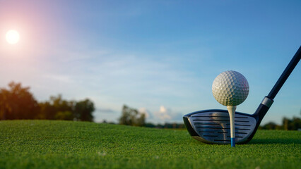 Golf clubs and balls on a green lawn in a beautiful golf course with morning sunshine.