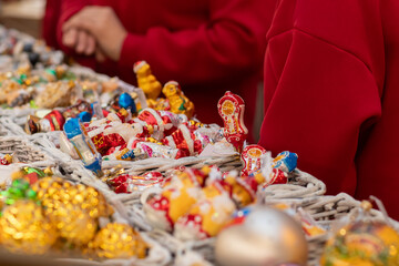 Christmas tree decorations toys on Christmas market, advent gifts in a bright seasonal shop, unique decorations for festive celebrations.