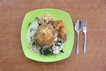 flat lay indonesia cuisine nasi pecel a rice with peanut sauce and fried egg warm rice 