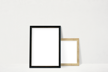 Black and beige picture frame mockup leaning against a white wall