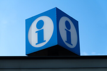 Blue information sign against clear sky