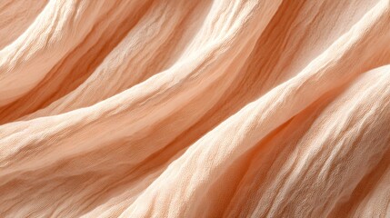 Peach colored crinkled fabric drapes gracefully with soft folds.
