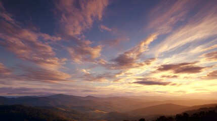 Obraz premium Mountain range under a vast sky with sunset clouds.