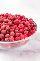 bowl of frozen cranberries on light background. Preservation of vegetables and fruits. Natural products
