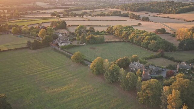 rom a golden-hour push-in, Wentworth Castle rises among trees and fields, with stone towers, pitched roofs, and landscaped lawns framed by rolling terrain and historic countryside.
