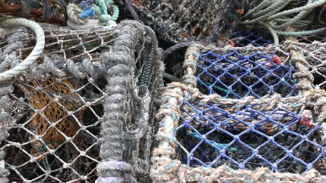 Fishing nets and ropes weathered with use shown in close-up detail at the harbor in Scarborough, North Yorkshire in England