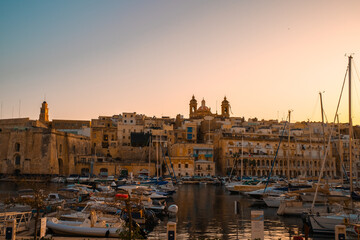 Birgu Waterfront, Malta – Boats and Historic Cathedrals at Sunset