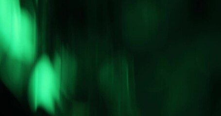 Abstract green blurred light leaks on dark background with copy space for design. Studio anamorphic lens flare bokeh effect for title or logo display. - Powered by Adobe