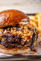 close-up of gourmet burger with caramelized onions and crispy topping