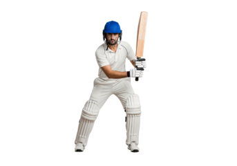 A cricketer in full gear poised to hit the ball with his cricket bat. He is wearing a helmet and pads, ready for action.