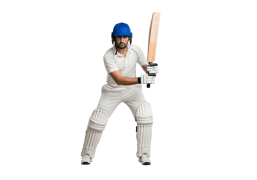 A cricketer in full gear poised to hit the ball with his cricket bat. He is wearing a helmet and pads, ready for action.