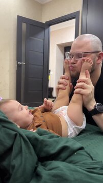 Playful moment between father and baby