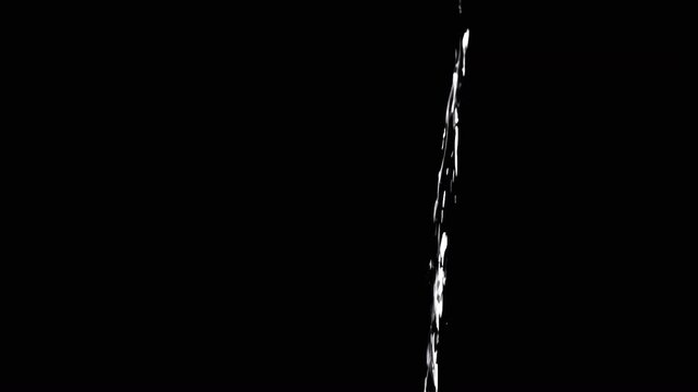 Thin Stream Of Water Pouring On Black Background. Close-up, slow motion. A clear stream of water flows down into empty space. Splashes. Abstract, texture, lighting. Clean water.