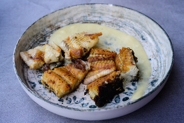Grilled Eel or Anguilla on Patato Puree, a Speciality Dish from Comacchio at the Delta of the River Po in Italy