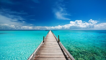 beautiful tropical seascape with wooden pier leading to turquoise ocean horizon under blue summer sky