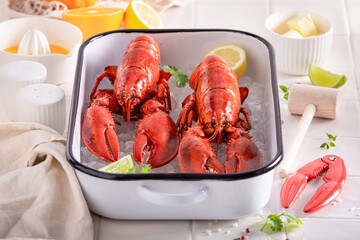 Teasty red lobster with hammer and tongs.