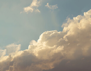 Natural sky background with cumulus clouds and warm tones