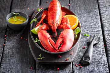 Cooked red lobster with butter and orange sauce.