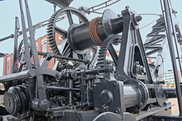 Detail with several cogs of an old industrial loading crane in the port of Ghent, Belgium 