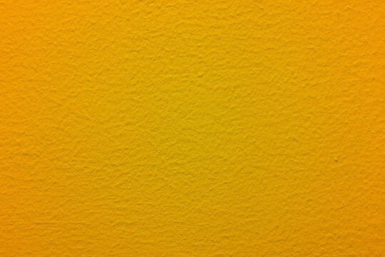 yellow wall texture grudge background with light in the middle and dark on the edges