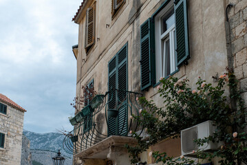 Green louvered shutters and iron balcony