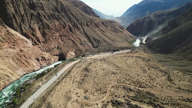 The Kokemeren river running through the picturesque landscape of Kyzyl Oi Village, Kyrgyzstan. Mountains are in the background.