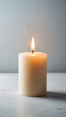 Softly glowing wax pillar on white surface