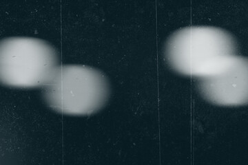 Dark textured overlay with light areas and fine surface imperfections. Subtle scratches and particle details add depth and character, suitable for use in design, photography, or digital art projects.
