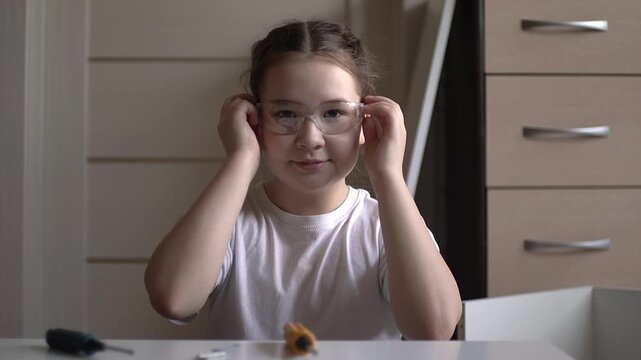 Teenage girl assembling furniture. Furniture repair. Slow motion. High quality 4k footage