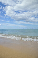Tranquil Seashore with Blue Sky and Gentle Waves