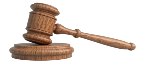 Polished wooden gavel resting on circular base, isolated against black