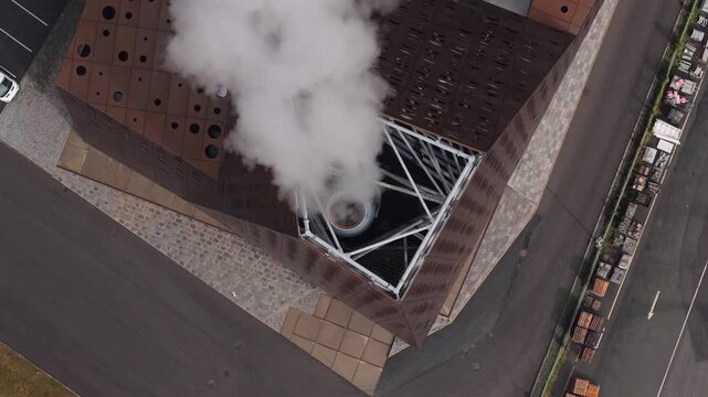 Power plant steam plume, energy production site, drone capture.