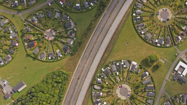 Top-down of Brondby Haveby, organized circular homes amid trees, Denmark.