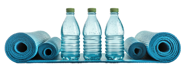 Rolled yoga mats flank three water bottles on a turquoise mat