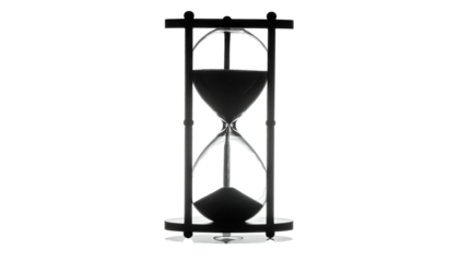 Silhouette hourglass showing flowing sand. Time passing concept, black background