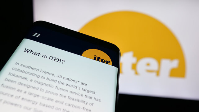 Stuttgart, Germany - 10-06-2025: Mobile phone with website of nuclear fusion power reactor project ITER on screen in front of logo. Focus on top-left of phone display.