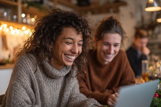 Two friends joyfully browsing online sales on cozy winter day, s - Powered by Adobe