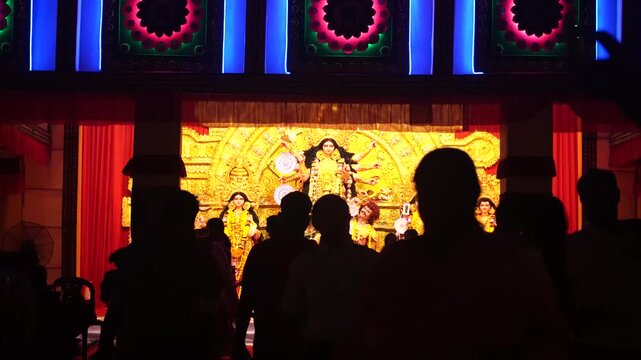 Long Shot of Maa Durga inside a decorated, vibrant, colorful pandal during the World's Largest Festival, Durga Puja in the city of Kolkata, India.