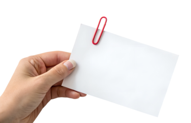 A hand holds a blank white note paper with a bright red paperclip attached, ready for writing; this is a transparent, isolated png.