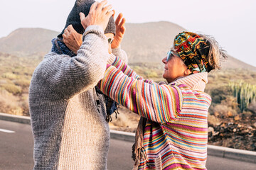 Senior couple outdoors enjoying a romantic moment together, smiling and in love, concept of active...