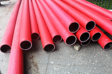 Red communication pipes close-up. Laying of communications