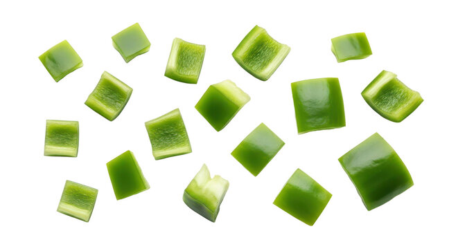 Freshly chopped green bell pepper pieces scattered on a clean white background, ideal for culinary use and healthy eating