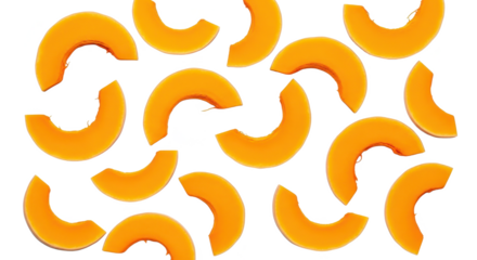 Bright orange crescent-shaped squash slices scattered artfully across a clean white backdrop