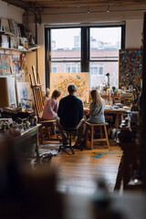 Two children learn painting from an artist in a cozy studio with colorful artworks